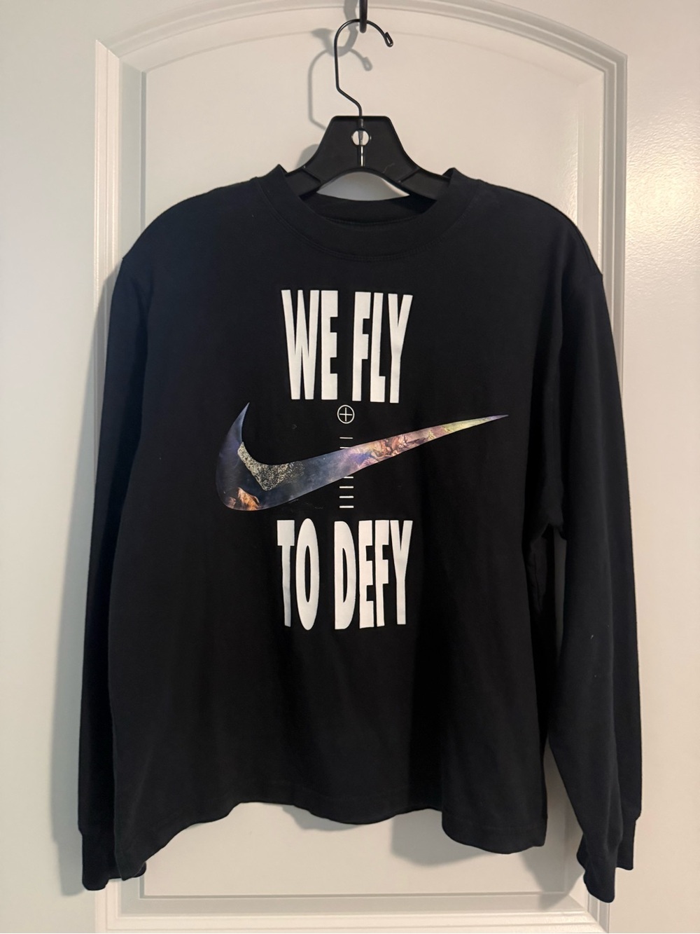 Nike Black Long-Sleeve Tee with iridescent Swoosh & 'We Fly To Defy' Graphic